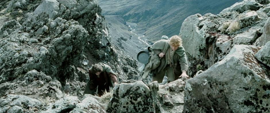Frodo and Sam climb to the top of a rocky hill while lost in Emyn Muil.