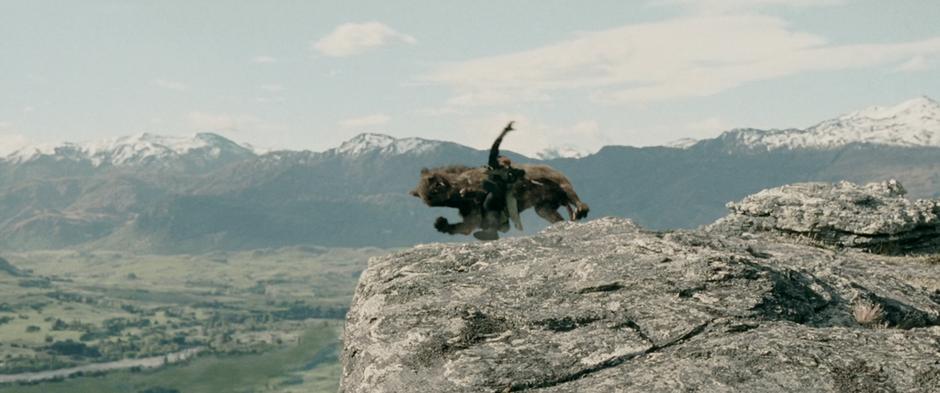 Aragorn is pulled over a cliff by a runaway Warg.