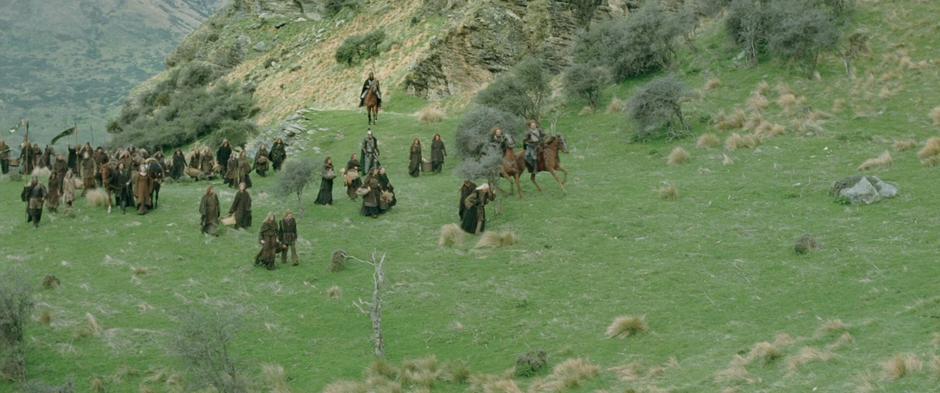 Refugees walk through a field just before the Warg attack.