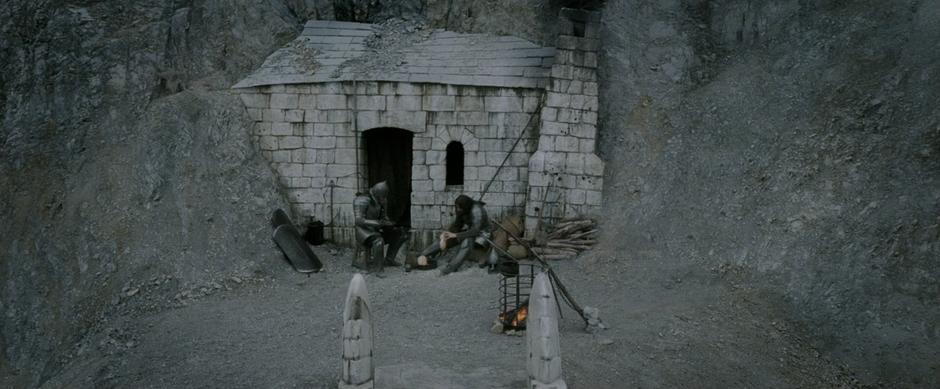 The beacon guards eat their dinner while unaware of Pippin lighting the beacon.