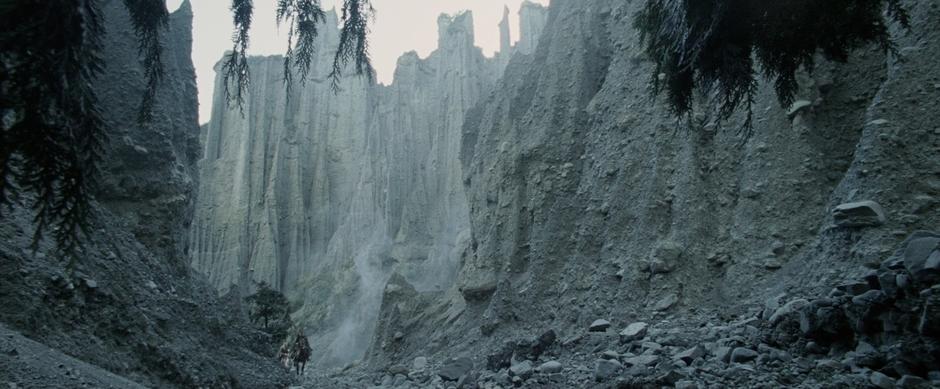 Aragorn, Legolas, and Gimli wander through the pinnacles.