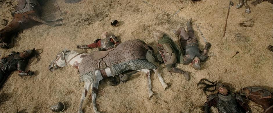 Eowyn crawls over to Theoden who is pinned under his horse.