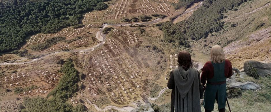 Aragorn and Theoden look down at the Rohirrim gathering for war.