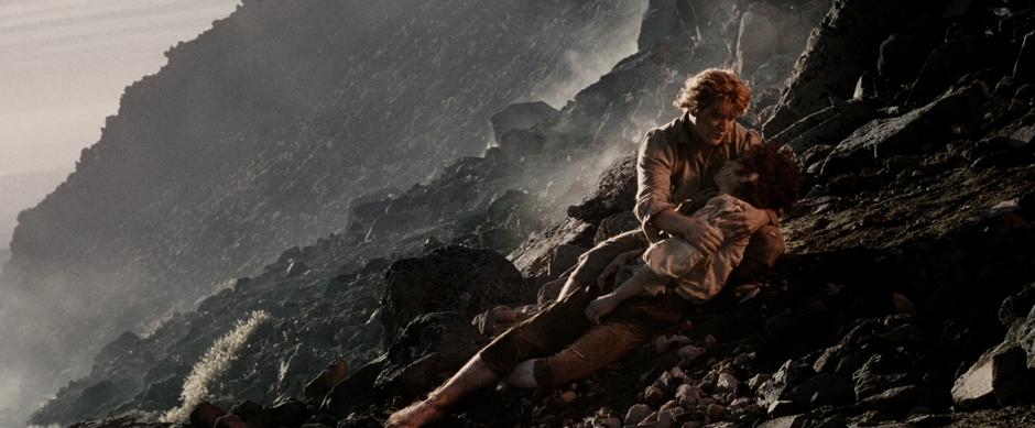 Sam holds Frodo after he collapsed on the way up the mountain.