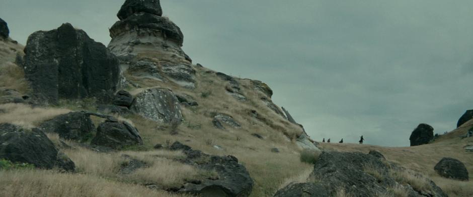 Aragorn and the Hobbits walk across a hilltop and see Weathertop for the first time.