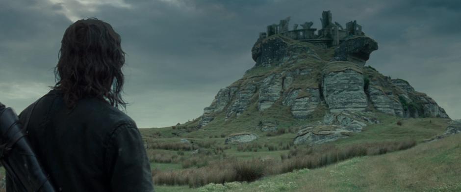 Aragorn looks up at Weathertop and explains its history and importance to the Hobbits.