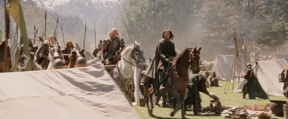 Aragorn and Theoden ride through the Rohirrim camp.