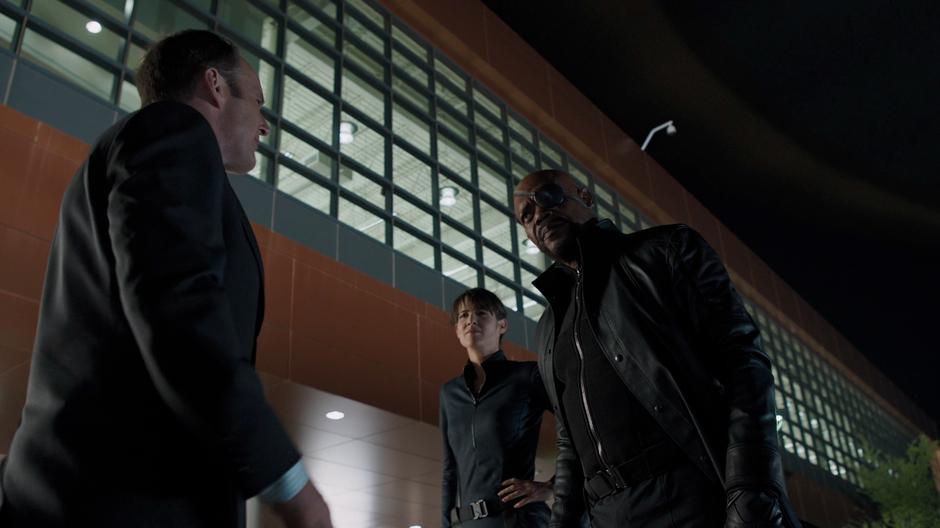 Agent Coulson greets Nick Fury and Maria Hill after they get off the S.H.I.E.L.D. helicopter.
