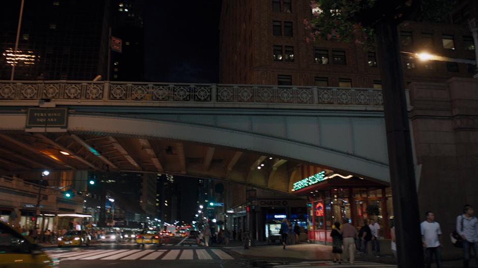 Iron Man flies down Park Avenue towards his skyscraper.