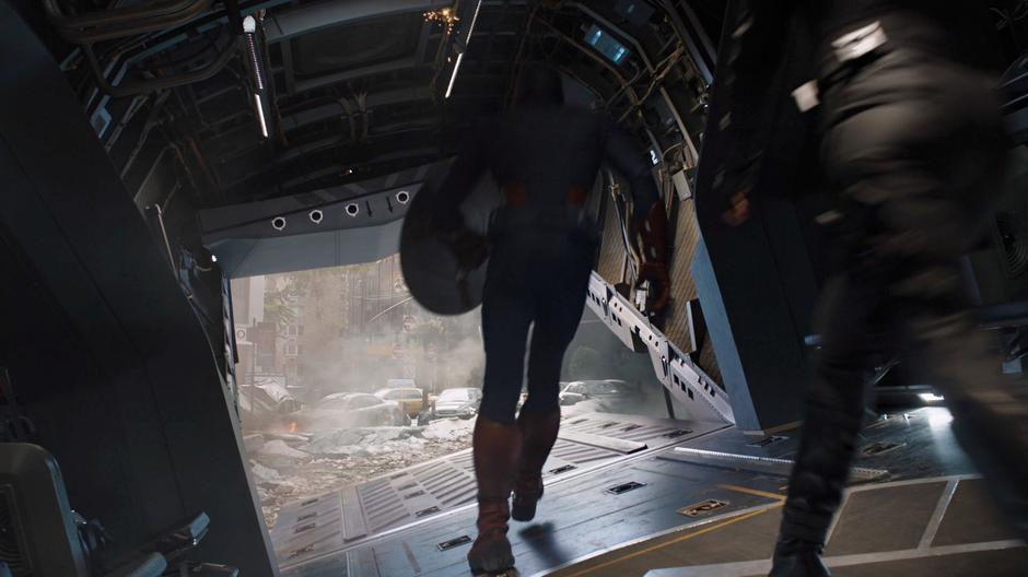 Captain America walks out of the Quinjet followed by Black Widow.