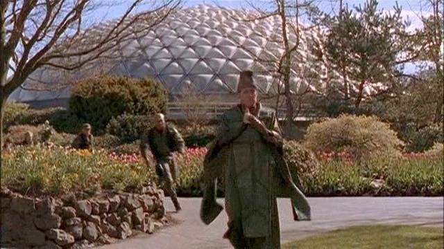 The Keeper runs away from the dome while being pursued by SG-1.