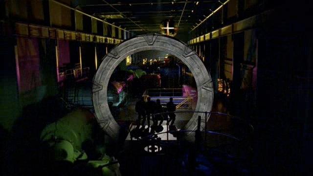 SG-1 arrives inside a factory on a new world.
