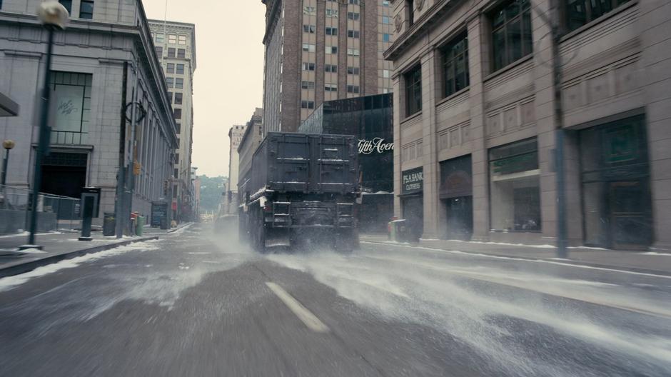 The bomb truck races through an intersection.