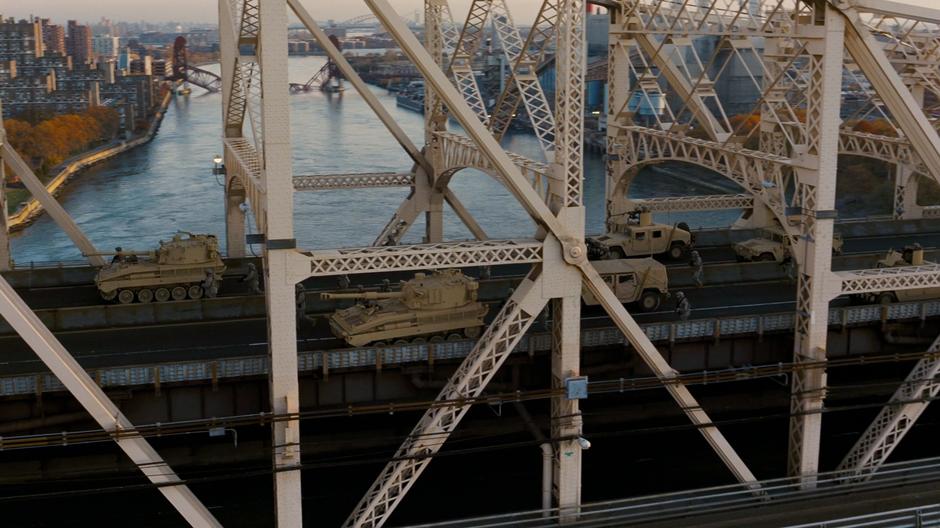 National Guard forces pull across the bridge after Bane announces his plans for the city.