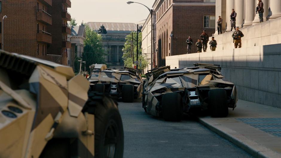 Bane's troops and tumblers form up outside the prison.