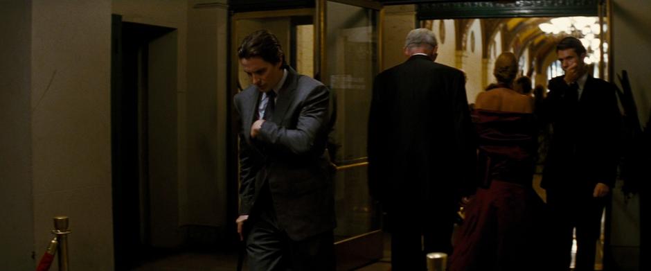 Bruce walks out of the party and attempts to find his valet ticket.