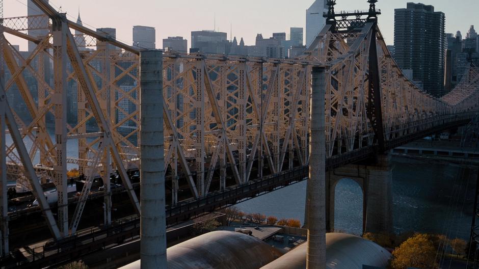 Relief trucks drive across the bridge into Gotham.