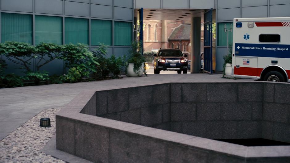 Blake drives his car up to the door of the hospital.