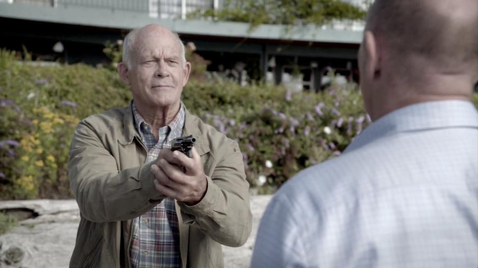 Jerry Carp points his gun at Henry after Henry realizes the truth.