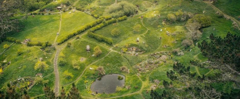 Overhead view of Bilbo running through Hobbiton on his way to catch up with the dwarves.