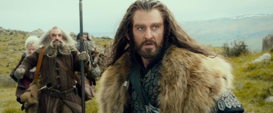 Thorin comes to a halt and looks at the wargs in the distance with the rest of the party following behind.