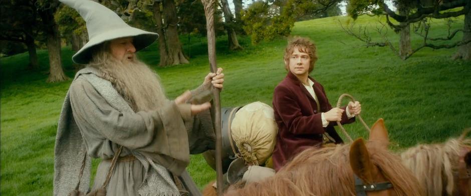 Gandalf catches one of the purses and assures Bilbo that he had faith.