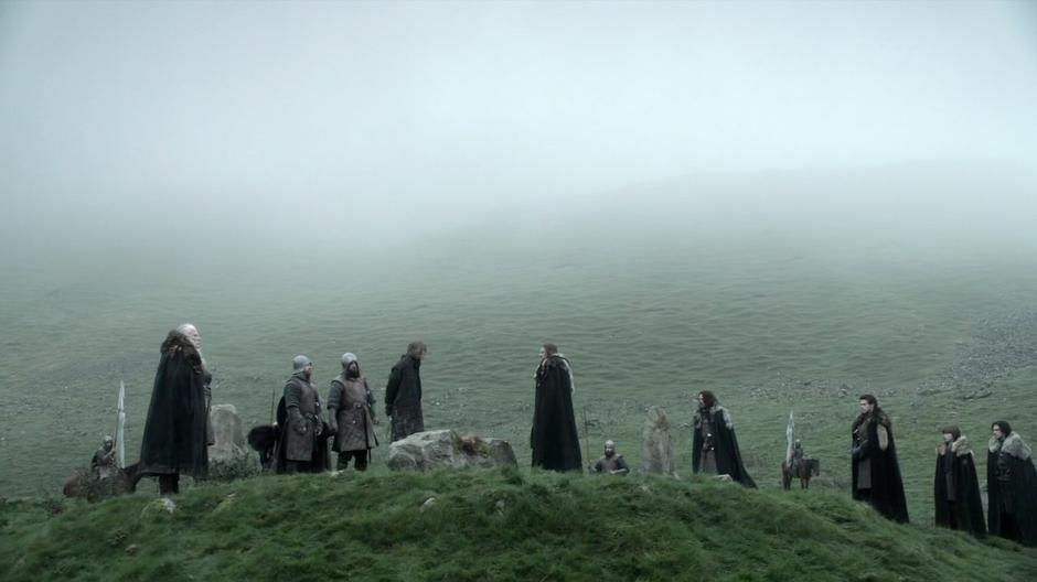 Ned Stark sentences the Night's Watch deserter to death while his family watches.