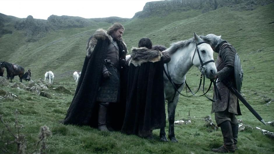 Ned talks to Bran about the execution while the kid prepares his horse.