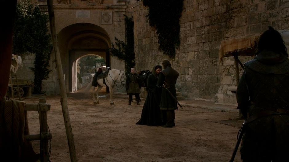 Ned says goodbye to Catelyn at the gate.