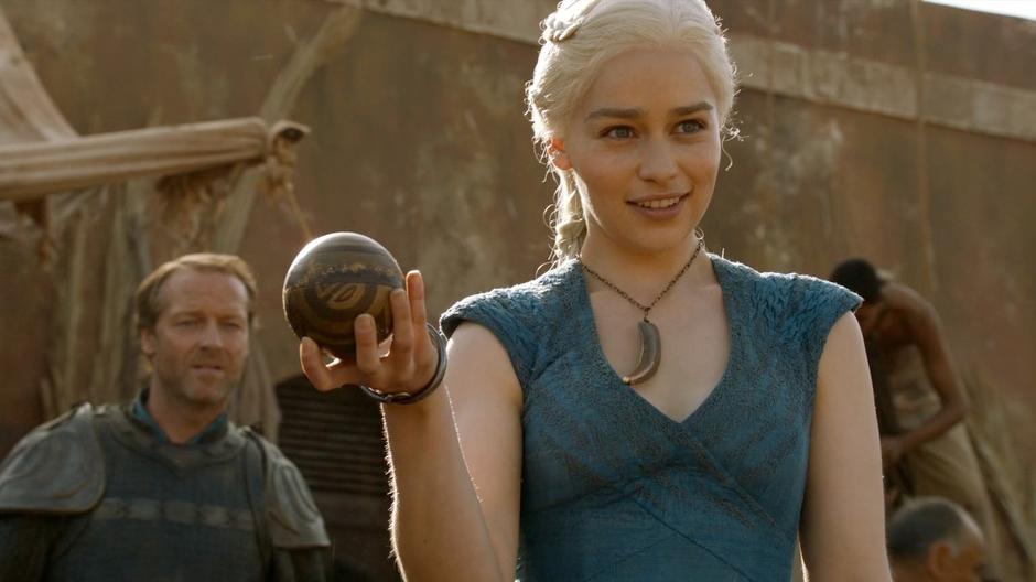 Daenerys holds the orb given to her by the creepy child while Ser Jorah looks on.