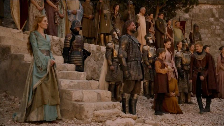 Joffrey walks away impatiently while the rest of the family still watches Myrcella departing.