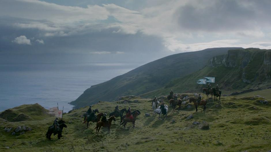 Wide establishing shot of the two groups meeting on a hilltop.