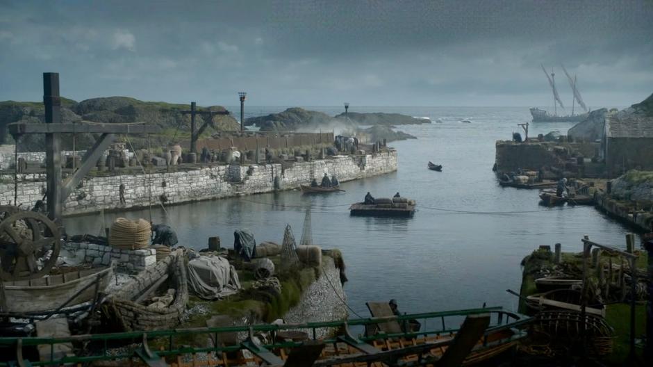 Theon is rowed into the harbour.