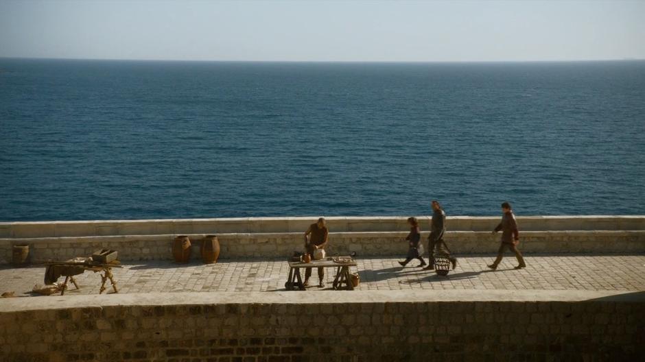 Tyrion and Bronn discuss pay while walking across the upper wall.