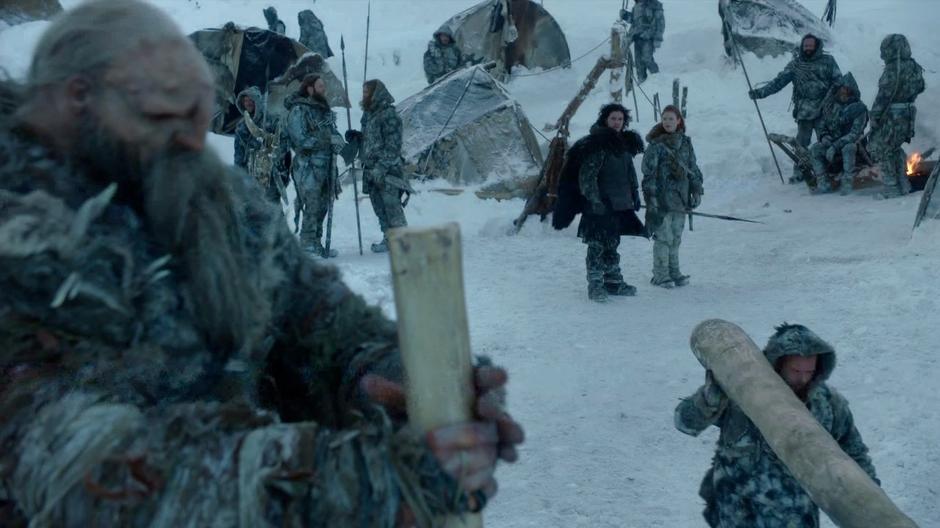 Jon Snow and Ygritte watch one of the giants pound a post into the ground.