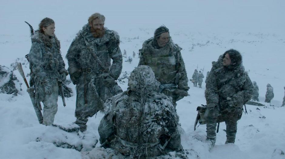 Mance Rayder, Ygritte, and Jon Snow stand around talking to a Warg.