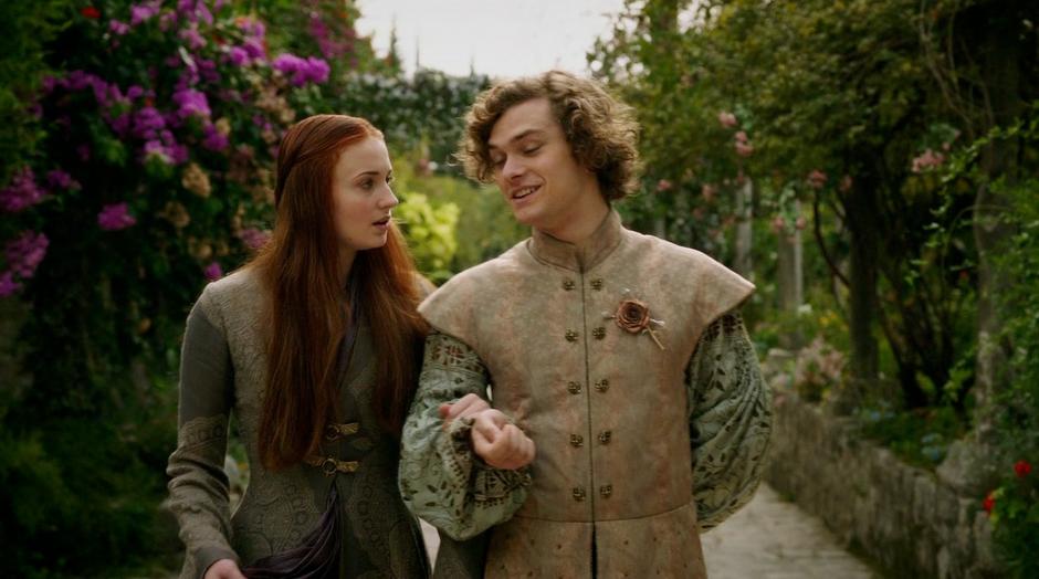 Sansa is escorted through the gardens by Lancel Tyrell.