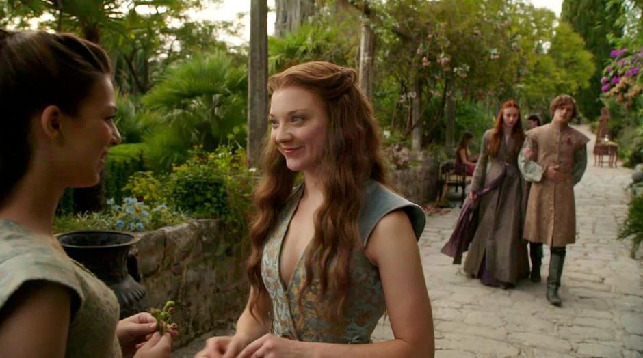 Sansa and Lancel approach Margaery who is talking with some girl.