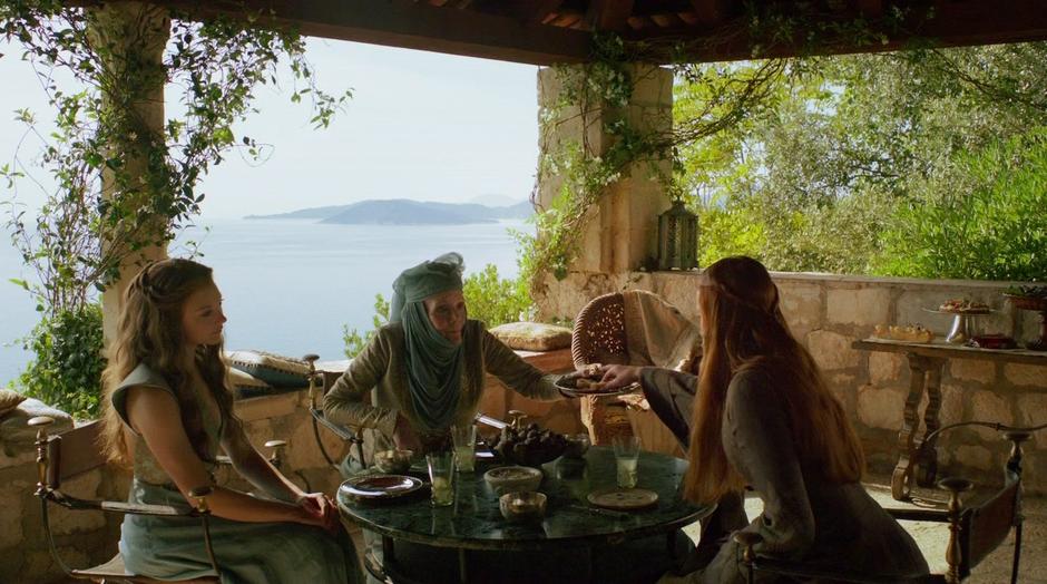 Sansa takes a snack from Olenna Tyrell.