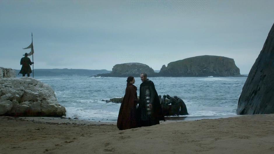Stannis talks with Melisandre on the beach.
