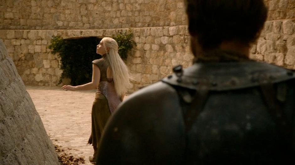 Ser Jorah follows Daenerys while she searches for the entrance to the tower.