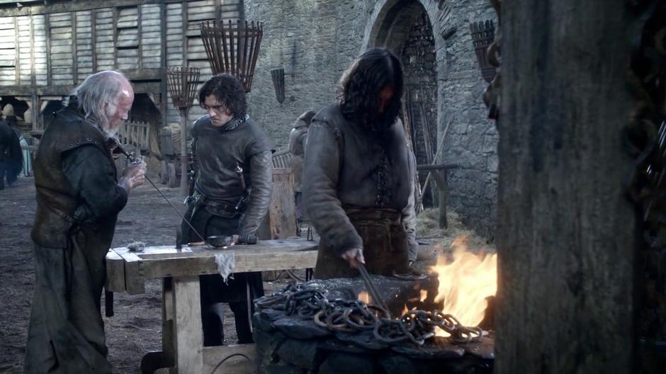 Mikken shows Jon Snow the sword he created for Arya.