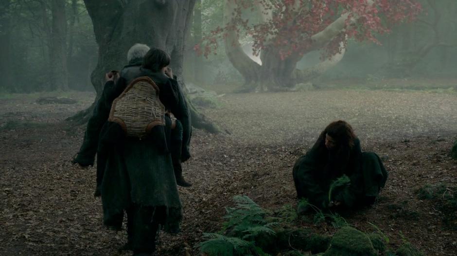 Hodor carries Bran through the wood while Osha picks herbs nearby.