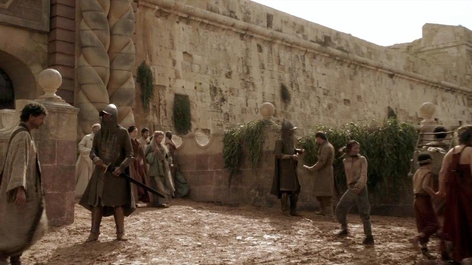 Arya arrives back at the King's Gate after sneaking out through a secret passage.