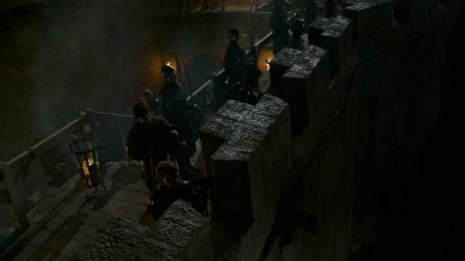 Tyrion reviews the defenses with Podrick from atop the wall.