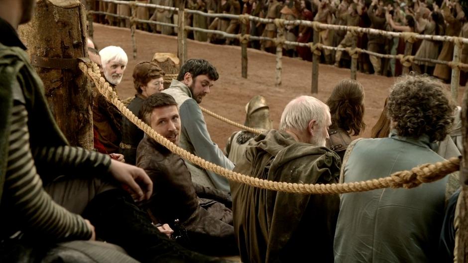 Littlefinger looks back and says something to Renly during the tournament.