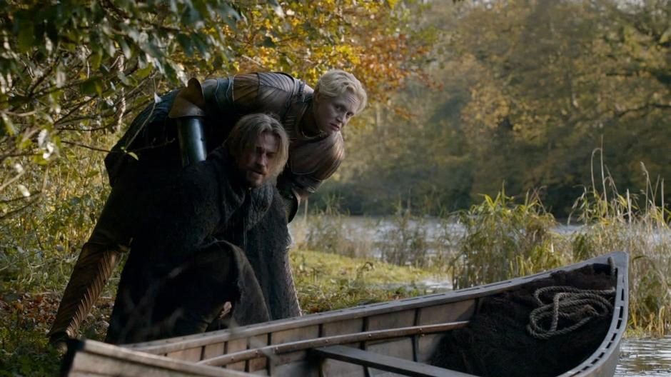 Brienne looks downriver at the bridge to make sure no one is watching.
