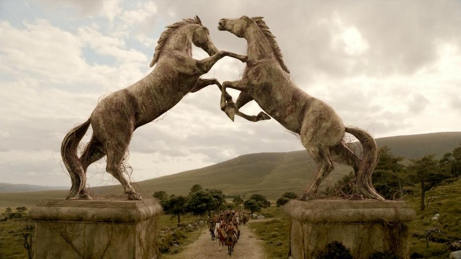 Khal Drogo's group rides up to the statues at the entrance to Vaes Dothrak.