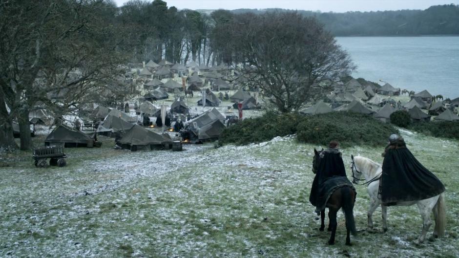 Catelyn and Ser Rodrik look down at the war camp.