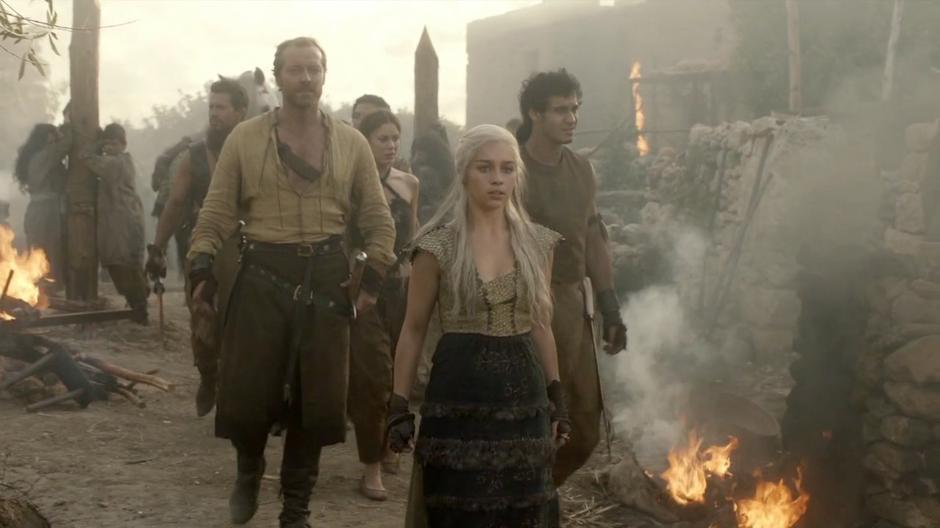 Daenerys and Ser Jorah walk through the village as the Dothraki are raping and pillaging.